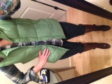 green vest, green flannel shirt, jeans, brown boots
